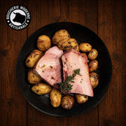 Travers de porc fondants accompagnés de pommes de terre rôties, prêts à réchauffer.